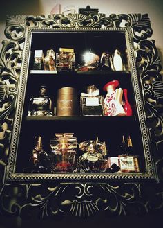 A baroque frame containing perfumes 